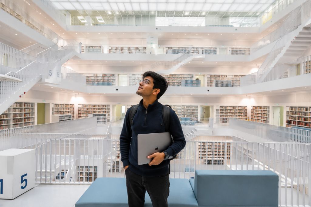 Student in the library of University of Stuttgart